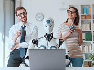 robot typing on a computer in front of humans